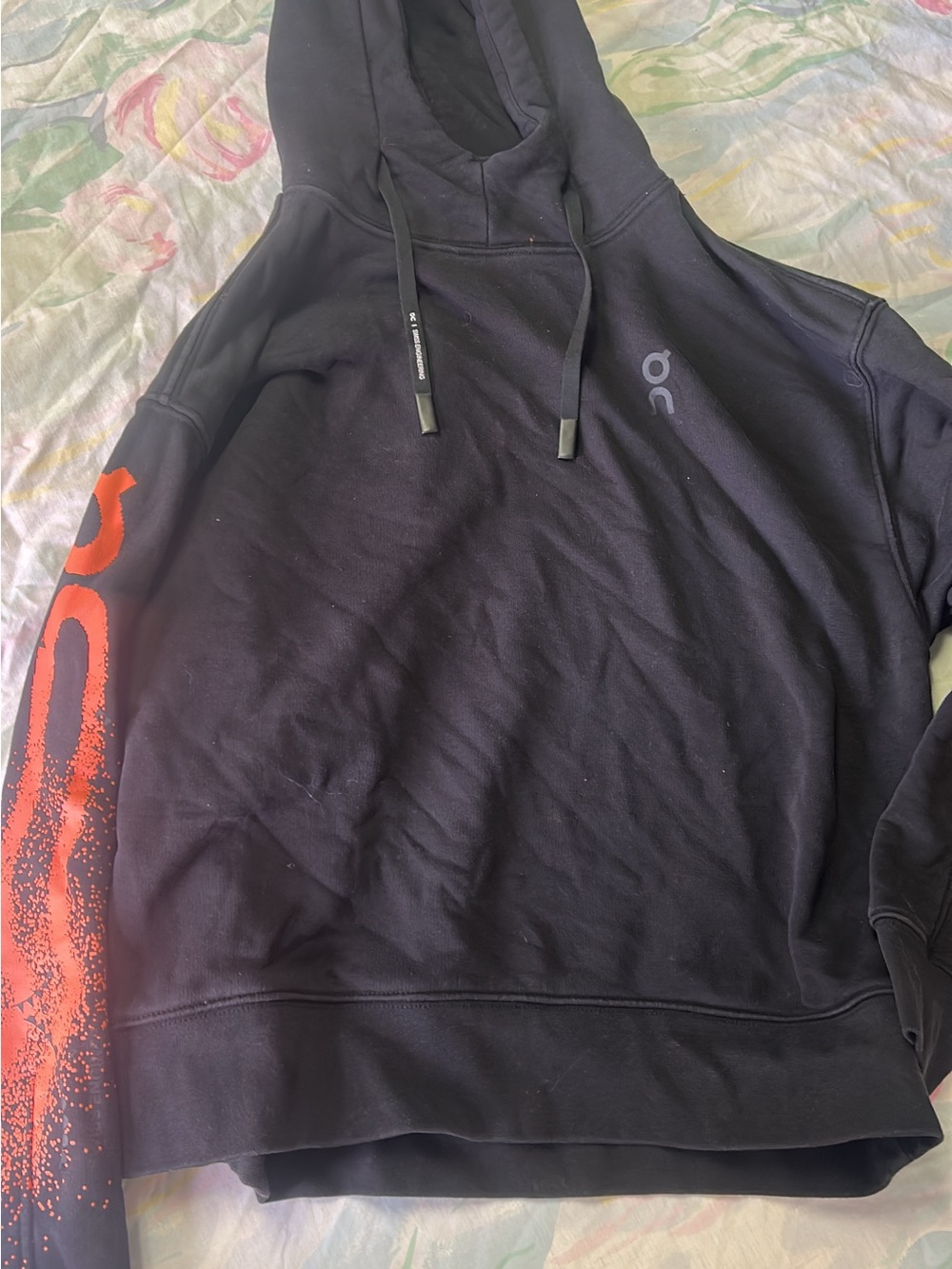On Running Black Hoodie with Red Sleeve Graphic